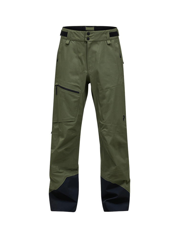Front view of the pine needle green Peak Performance Men's GORE-TEX C-Knit 3L Shell Pants featuring 3-layer GORE-TEX fabric with C-KNIT backer technology, YKK AquaGuard leg ventilation zips, an adjustable velcro waistband, and reinforced Cordura lower leg scuff guards.