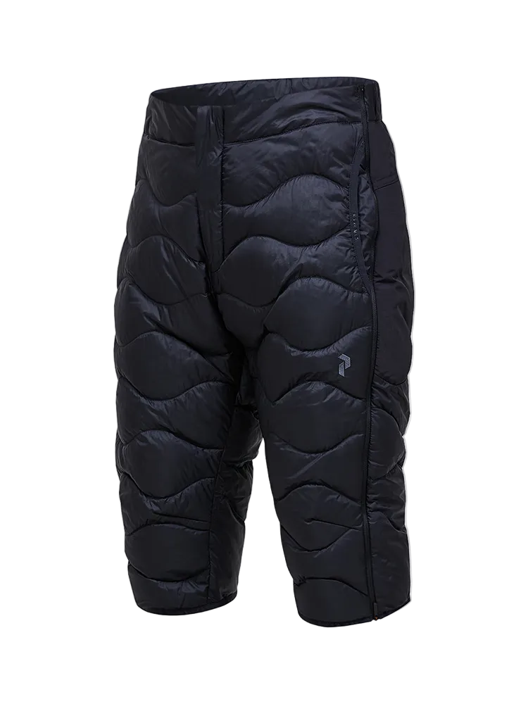 Side view of black Peak Performance Men's Helium Down Shorts featuring ultra-lightweight windproof fabric, signature wave quilting, 700-fill-power down insulation, and full-length side zips.