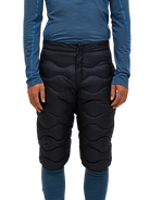 Front view of black Peak Performance Men's Helium Down Shorts featuring ultra-lightweight windproof fabric, signature wave quilting, 700-fill-power down insulation, and full-length side zips.