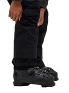 Side view of the Peak Performance Men's Maroon HIPE 2L Insulated Shell Pants featuring 2-layer HIPE 2-way stretch fabric, an adjustable velcro waistband, articulated knees, and reinforced Cordura lower leg scuff guards.