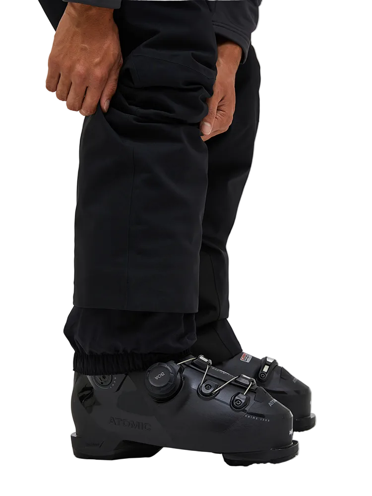 Side view of the Peak Performance Men's Maroon HIPE 2L Insulated Shell Pants featuring 2-layer HIPE 2-way stretch fabric, an adjustable velcro waistband, articulated knees, and reinforced Cordura lower leg scuff guards.