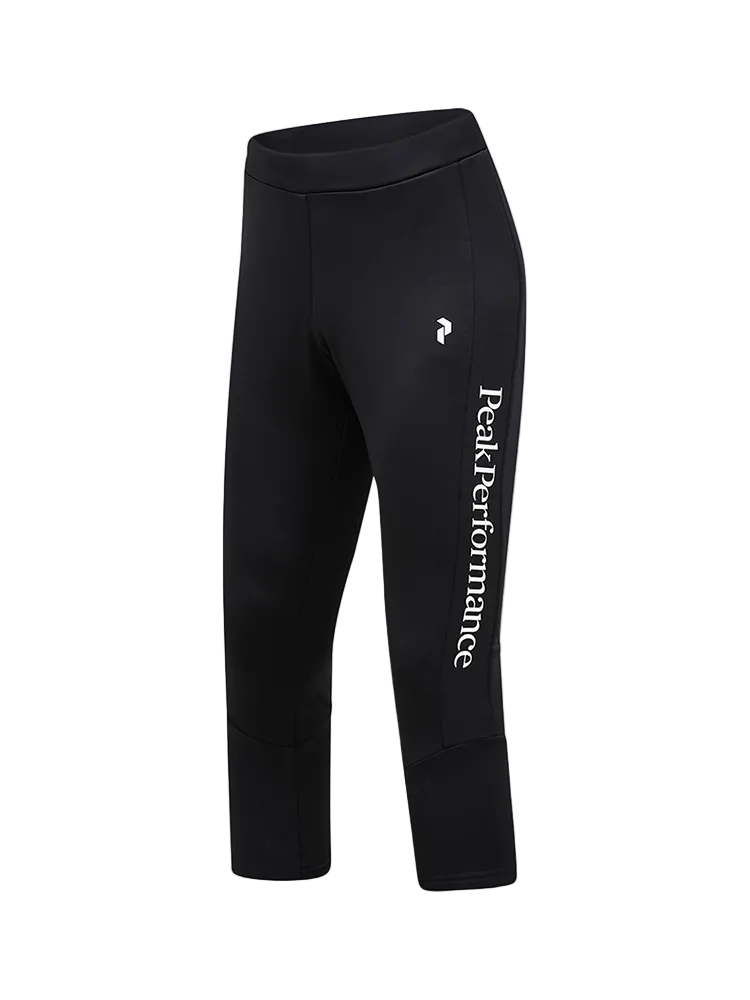 Side view of black Peak Performance Men's Rider Essentials 3/4 Midlayer Pants featuring 4-way stretch technical fleece, a boot-compatible 3/4 leg length, flatlock seams, and a low-profile elastic waistband.