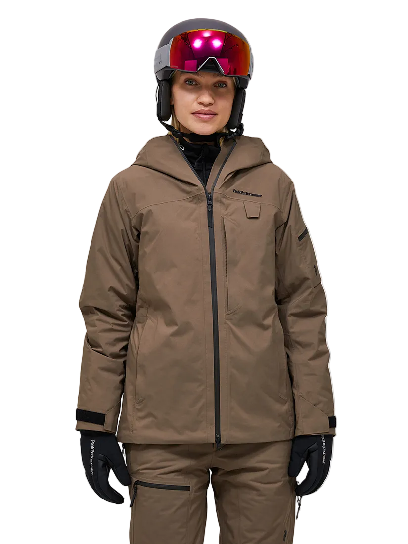 Front view of a brown Peak Performance Women's Alpine GORE-TEX 2L Insulated Shell Jacket featuring a 2-layer GORE-TEX waterproof shell, YKK AquaGuard storm zippers, an integrated radio pocket, and a helmet-compatible hood.