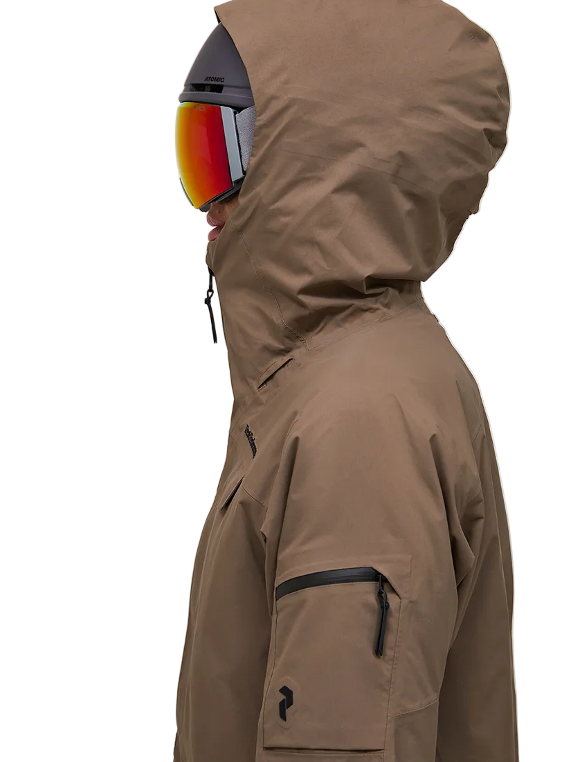 Side view of a brown Peak Performance Women's Alpine GORE-TEX 2L Insulated Shell Jacket featuring a 2-layer GORE-TEX waterproof shell, YKK AquaGuard storm zippers, an integrated radio pocket, and a helmet-compatible hood.