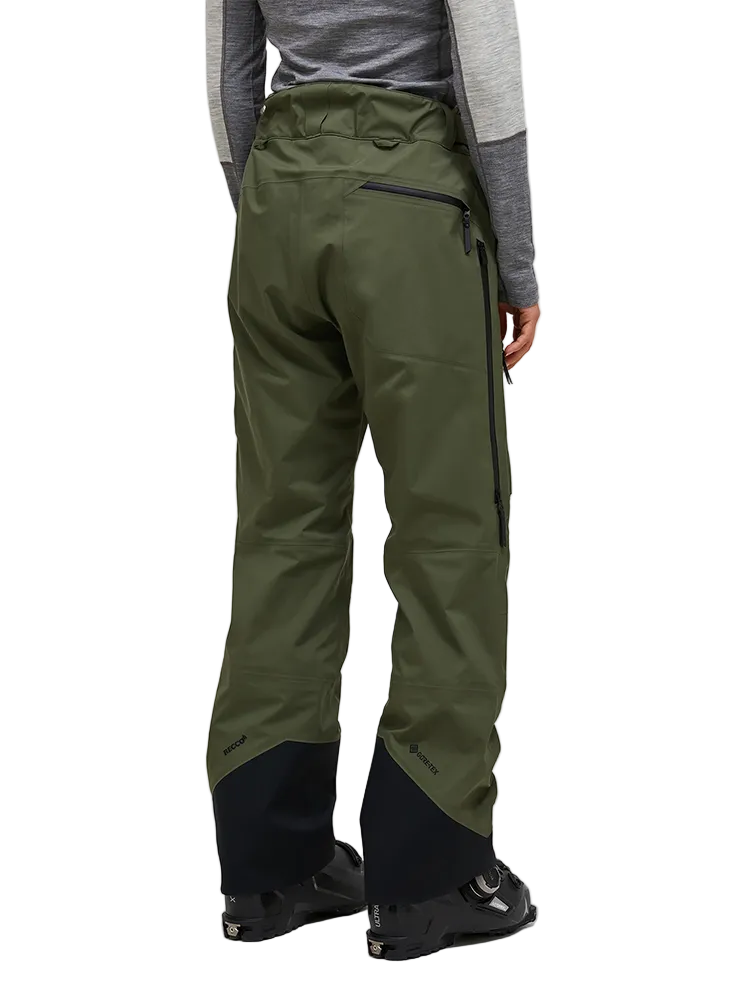 Rear view of the pine needle green Peak Performance Women's Alpine GORE-TEX C-Knit 3L Shell Pants featuring 3-layer GORE-TEX fabric with C-KNIT backer technology, YKK AquaGuard leg ventilation zips, an adjustable velcro waistband, and reinforced Cordura lower leg scuff guards.