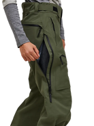 Side view of the pine needle green Peak Performance Women's Alpine GORE-TEX C-Knit 3L Shell Pants featuring 3-layer GORE-TEX fabric with C-KNIT backer technology, YKK AquaGuard leg ventilation zips, an adjustable velcro waistband, and reinforced Cordura lower leg scuff guards.
