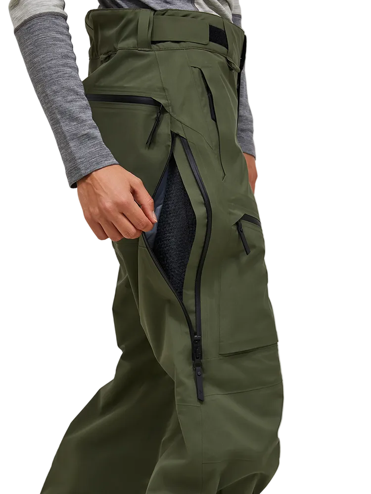 Side view of the pine needle green Peak Performance Women's Alpine GORE-TEX C-Knit 3L Shell Pants featuring 3-layer GORE-TEX fabric with C-KNIT backer technology, YKK AquaGuard leg ventilation zips, an adjustable velcro waistband, and reinforced Cordura lower leg scuff guards.