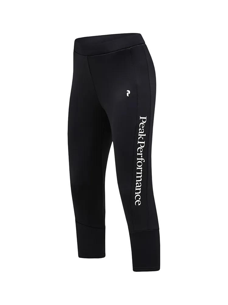 Side view of black Peak Performance Women's Rider Essentials 3/4 Midlayer Pants featuring 4-way stretch technical fleece, a boot-compatible 3/4 leg length, flatlock seams, and a low-profile elastic waistband.