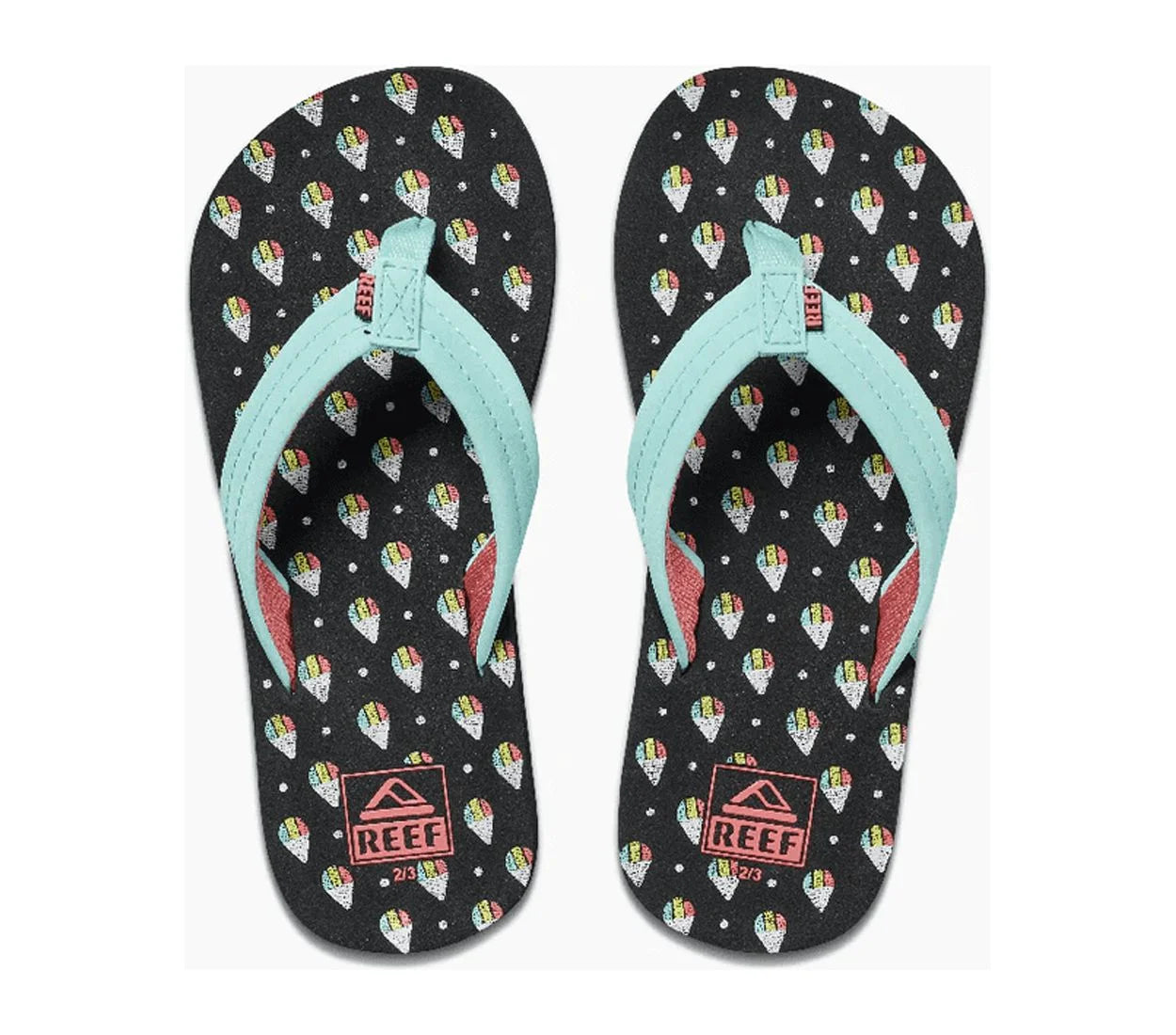 Pair of black and teal Reef Junior Ahi Snowcone flip-flops with colorful ice cream pattern and Reef logo on a white background