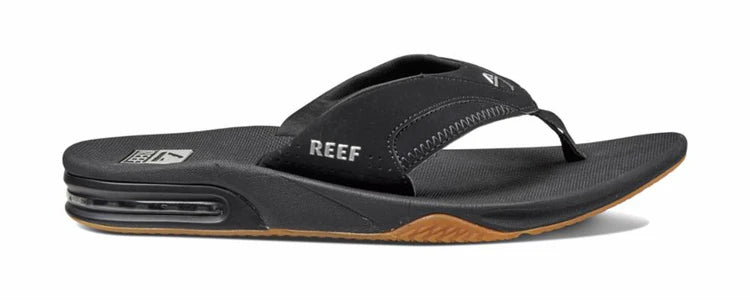 A black Reef Men's Fanning sandal on a white background
