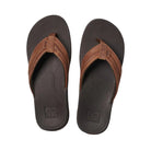 A pair of brown and black Reef Mens Leather Ortho Bounce Coast flip-flop sandals on a white background