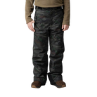 A boy wearing a pair of camo print Rossignol Boys' Ski Pants that are waterproof, breathable, stretchable, and insulated.