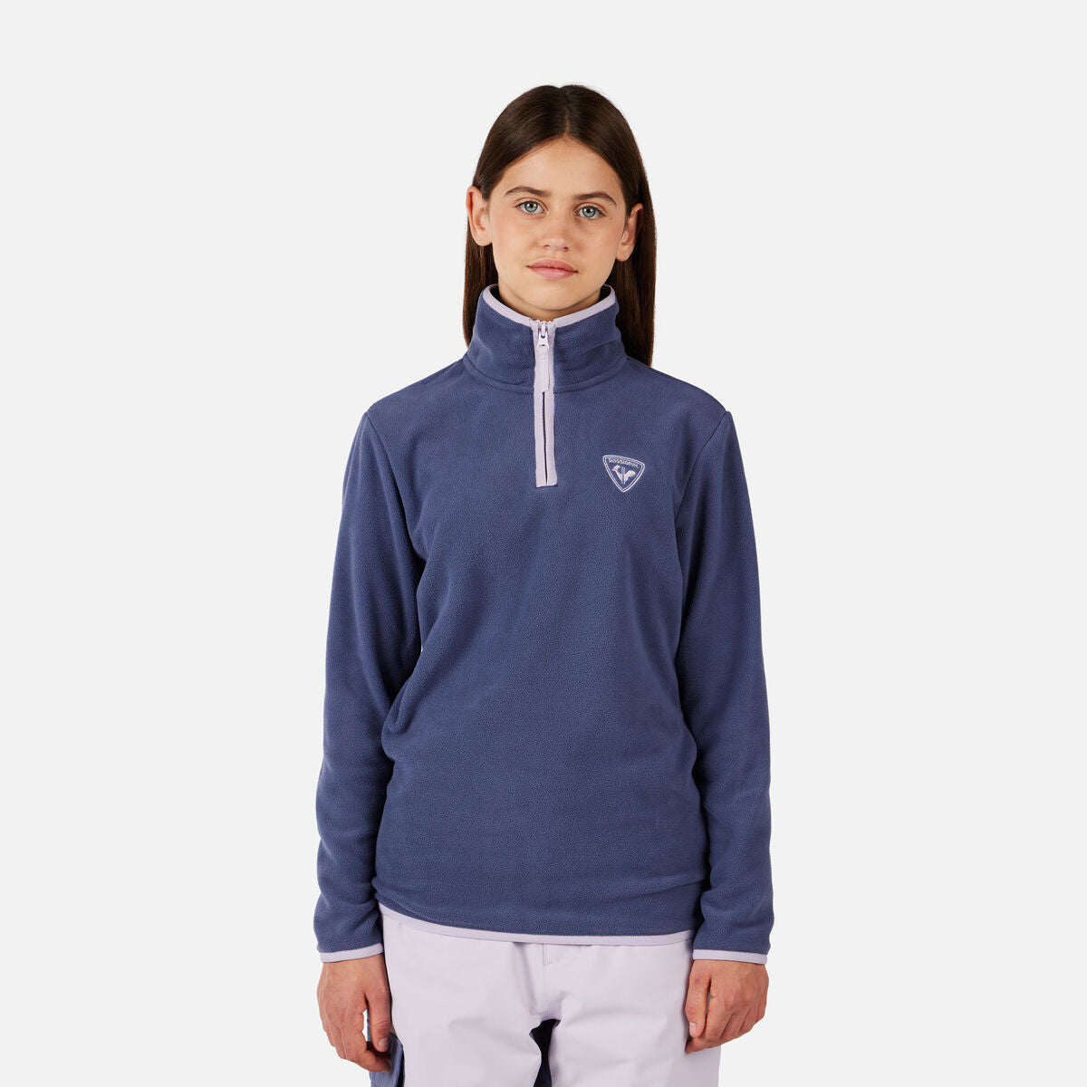 A girl wearing a purple Rossignol Girls' Strawpile Fleece sweater that is warm, stretchable, and breathable.