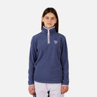 A girl wearing a purple Rossignol Girls' Strawpile Fleece sweater that is warm, stretchable, and breathable.