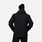 A man wearing a black Rossignol Men's Desafio 2L Shell Ski Jacket that is waterproof, stretchable, and breathable.