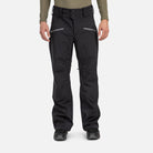 A man wearing a pair of black Rossignol Men's Evader Shell Ski Pants that are waterproof, breathable, and stretchable.