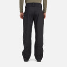 A man wearing a pair of black Rossignol Men's Evader Shell Ski Pants that are waterproof, breathable, and stretchable.