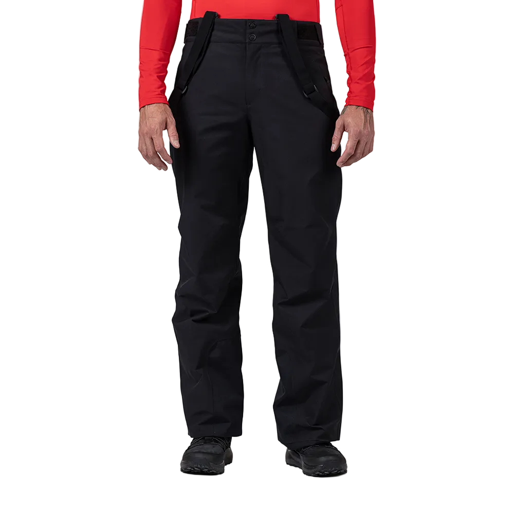 Front view of black Rossignol Men’s Insulated Ski Pants featuring waterproof membrane fabric, synthetic insulation, adjustable waist tabs, integrated boot gaiters, and reinforced hem scuff guards.