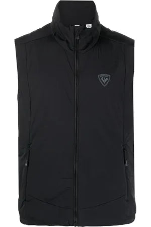 A black Rossignol Mens's Opside insulated vest, featuring a logo on the chest and adjustable drawstrings.