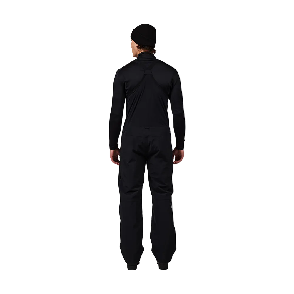Rear view of black Rossignol Men’s Outerlimits Insulated Bib Pants featuring high-chest bib construction, waterproof membrane fabric, adjustable shoulder suspenders, zippered thigh vents, integrated boot gaiters, and reinforced hem scuff guards.