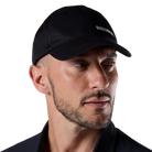 Front view of a black Rossignol Trucker Cap featuring a structured front panel, pre-curved visor, breathable rear mesh panels, and an adjustable snapback closure.
