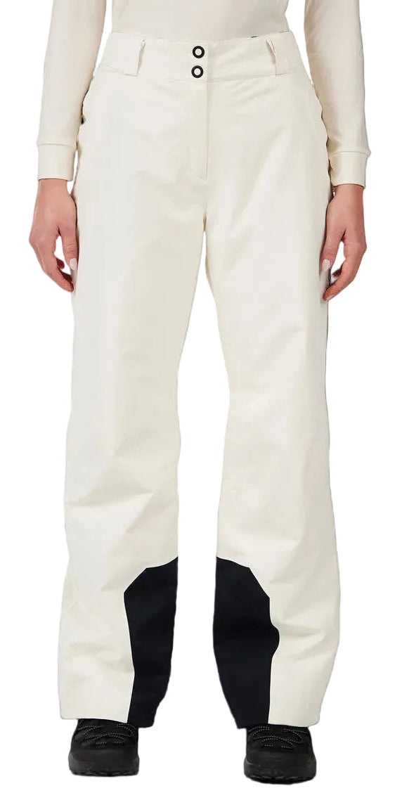 A woman wearing a pair of white Rossignol Women's Insulated Ski Pants that are waterproof, breathable, stretchable, and warm.