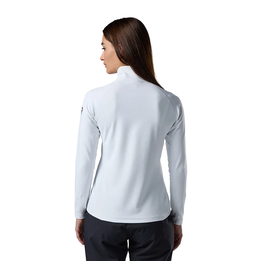 Rear view of a white Rossignol Women’s Midlayer Stretch 1/2 Zip Sweater featuring multi-directional stretch knit, thermal fleece interior, deep half-zip front zipper, and an ergonomic stand-up collar.