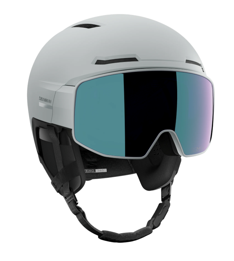 Salomon Driver Prime Sigma Plus Mips Helmet showing a hybrid shell with top ventilation ports, an integrated mirrored visor lens with a gradient tint, padded ear covers, and an adjustable chin strap system.