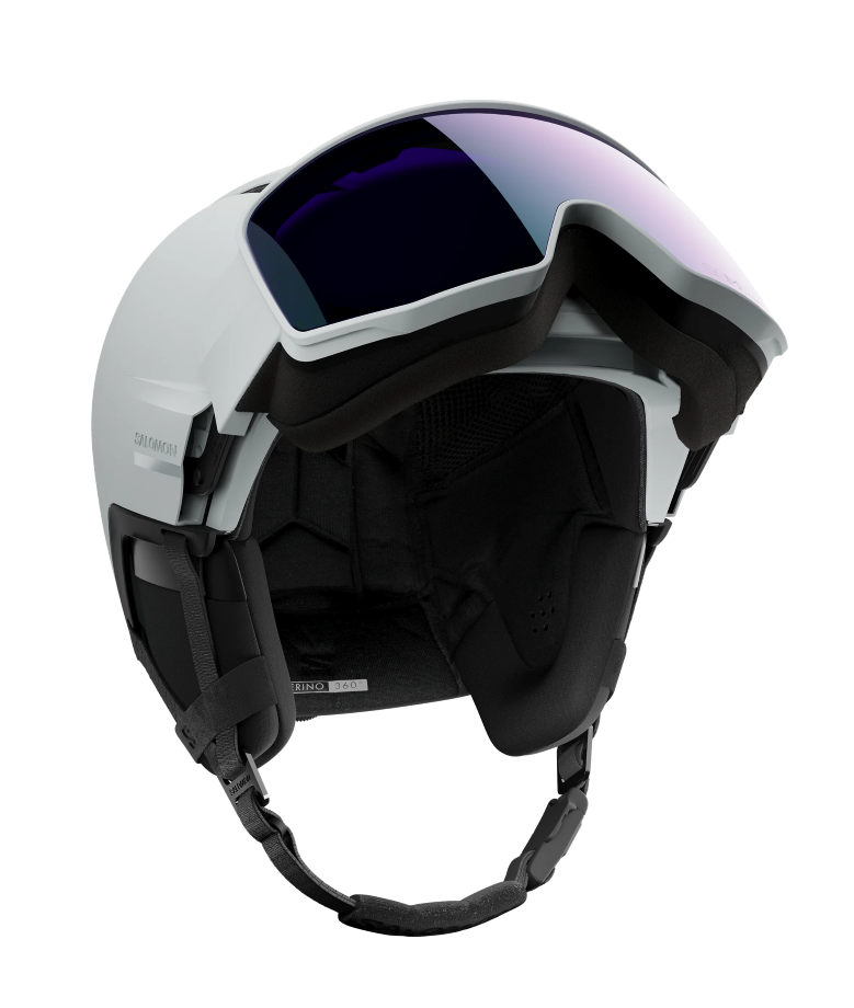 Salomon Driver Prime Sigma Plus Mips Helmet showing a hybrid shell with top ventilation ports, an integrated mirrored visor lens with a gradient tint, padded ear covers, and an adjustable chin strap system.