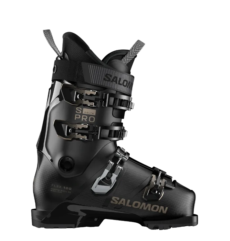 A Salomon S/PRO Delta 100 ski boot in black with gold lettering and silver buckles, that features a sturdy construciton and GripWalk soles, shown from a side profile.