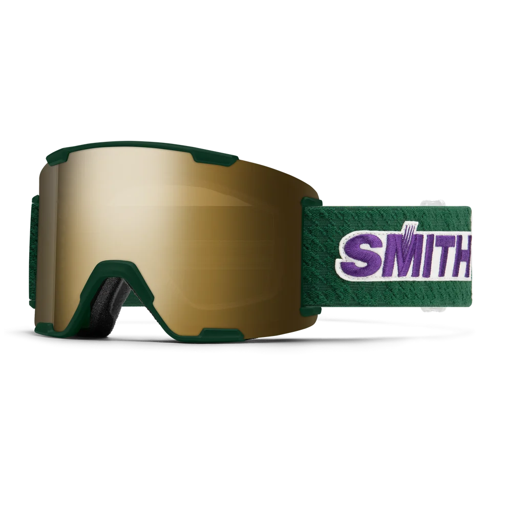 Smith Stash XL Asian Fit snow goggles with a dark green frame, a gold mirrored lens, and a green strap featuring the purple and white Smith logo.