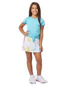 A girl wearing a white Sofibella Girls Spectrum UV Skort with a multicolour design on a white background.