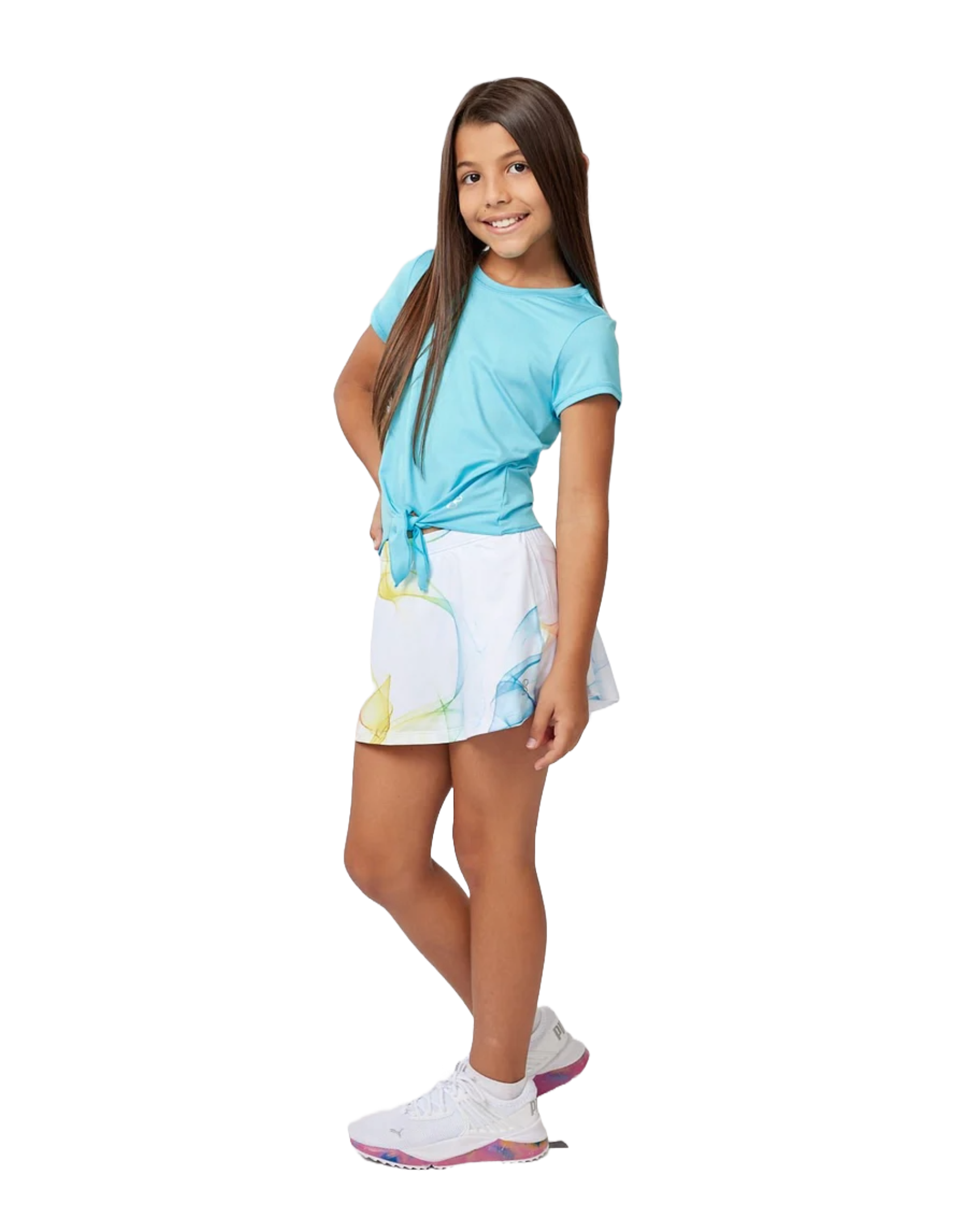 A girl wearing a white Sofibella Girls Spectrum UV Skort with a multicolour design on a white background.