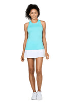 Woman wearing a light blue Sofibella Women's UV Colours Racerback Tank Top and white skirt on a white background