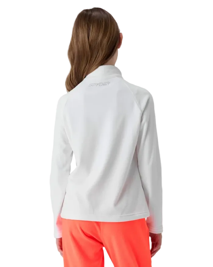 A girl wearing a Spyder Jr Girls’ Shimmer Bug 1/2 Zip Sweater featuring high-stretch velour fleece knit, YKK® reverse coil center front zipper, T-neck collar, and jeweled crystal logo.