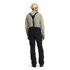 A man wearing a pair of black Spyder Bormio Ski Pants, which are waterproof, breathable, stretchable, and warm.