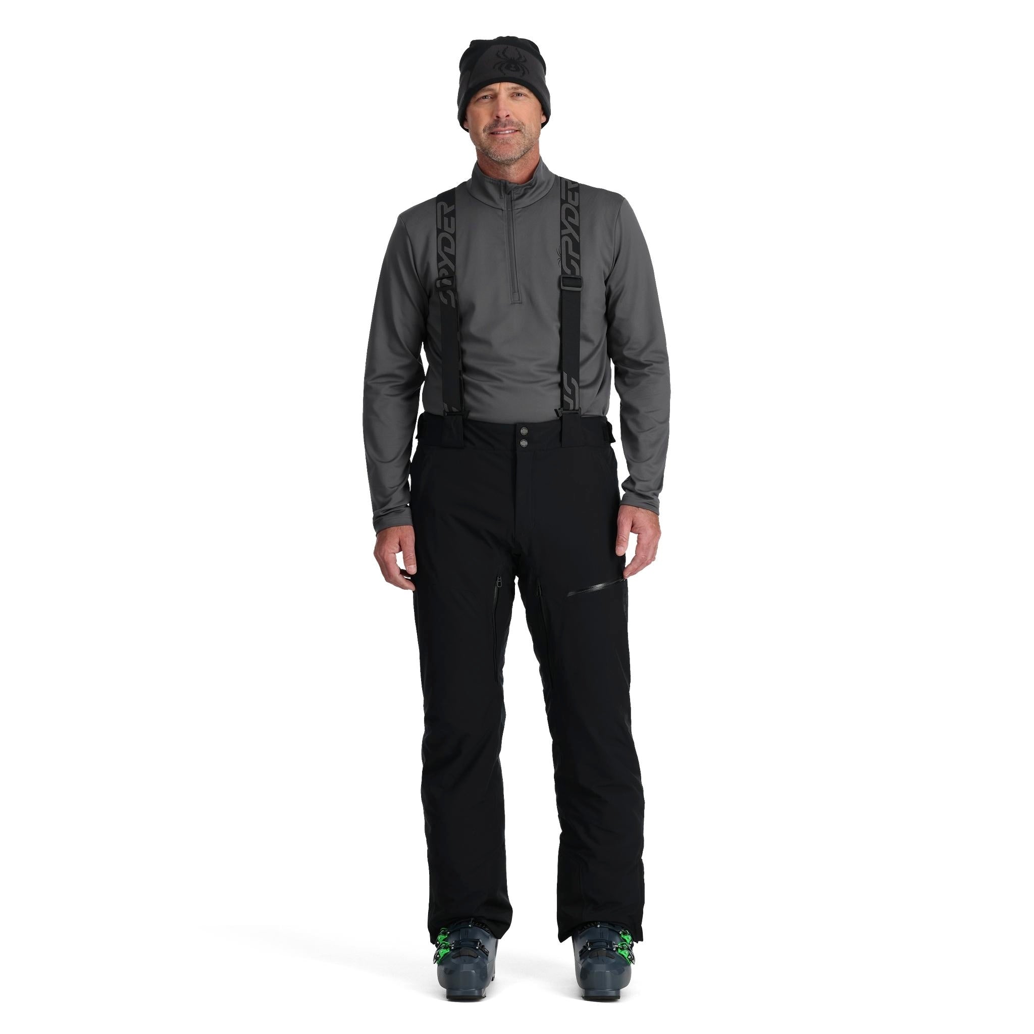 A man wearing a pair of black Spyder Men's Dare Ski Pants that are waterproof, insulated, breathable, and stretchable.