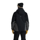 A man wearing a grey and black Spyder Men's Monterosa Ski Jacket that is waterproof, breathable, stretchable, and insulated.