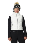 A woman wearing a white Spyder Women's Eastwood Down Vest that is waterproof, breathable, stretchable, and insulated with down.