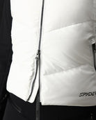 A close-up of a woman wearing a white Spyder Women's Eastwood Down Vest that is waterproof, breathable, stretchable, and insulated with down.