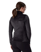 A woman wearing a Spyder Women’s Shimmer Bug 1/2 Zip Sweater featuring stretch velour fleece knit, YKK® reverse coil center front zipper, T-neck collar, and jeweled crystal logo.