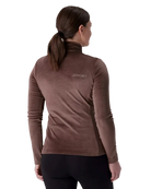 A woman wearing a Spyder Women’s Shimmer Bug 1/2 Zip Sweater featuring stretch velour fleece knit, YKK® reverse coil center front zipper, T-neck collar, and jeweled crystal logo.