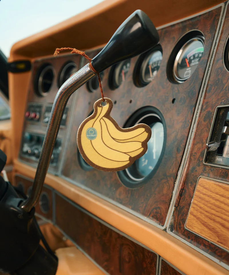 A yellow Sun Bum Banana Air Freshener in the shape of a banana