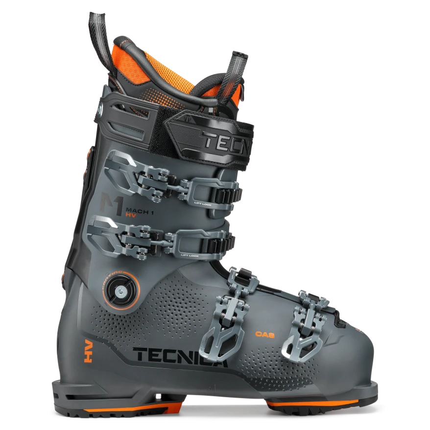 A TECNICA Mach 1 HV 110 ski boot in gray with orange and black details, featuring multiple buckles and a high volume design.