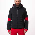 A man wearing a black and red Toni Sailer Men's Matti Ski Jacket made from premium fabrics and insulation that is waterproof, breathable, stretchable, insulated, and fashionable.