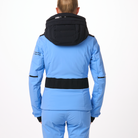 A woman wearing a blue and black Toni Sailer Women's Martha Ski Jacket that is made from premium fabrics and insulation that is waterproof, breathable, stretchable, and insulated.