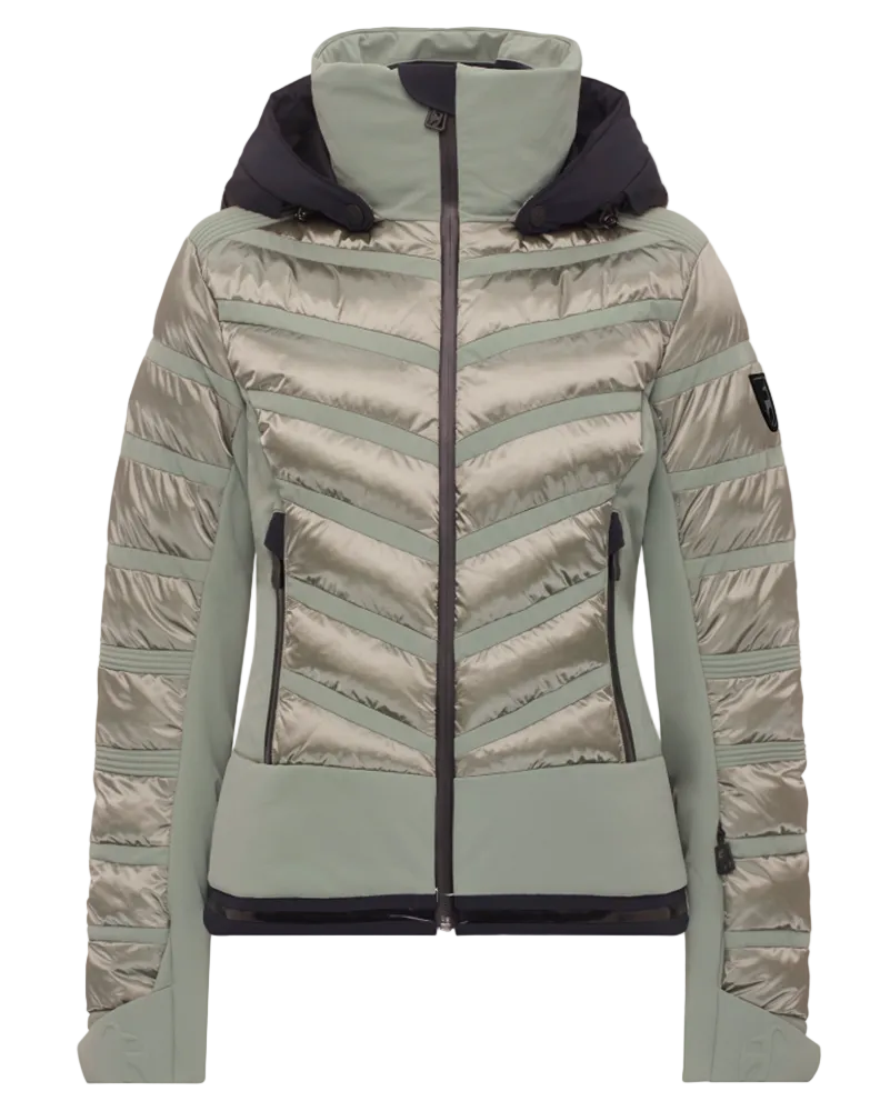 Toni Sailer Women’s Swinta Splendid Jacket showing 4-way stretch fabric with shiny jet-fabric accents, high-loft insulation baffles, YKK AquaGuard water-repellent zippers, forearm ski pass pocket, and elastic wrist gaiters with thumbholes.