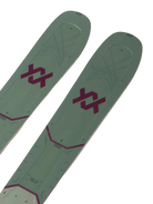 A pair of green and pink Volkl M7 Mantra W skis that are designed for all-mountain and freeride skiing, intended for expert female skiers.