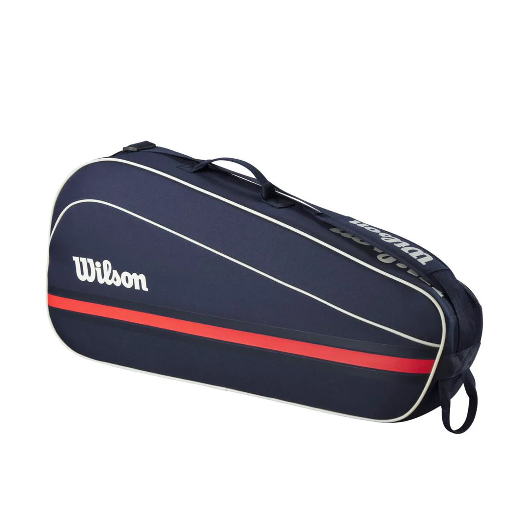 Wilson Team 3 Pack Racquet Bag featuring storage for up to three racquets, accessory pockets, durable construction, and an adjustable shoulder strap.